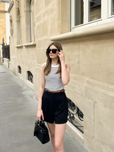 a lady wears a striped tank top with a black shorts